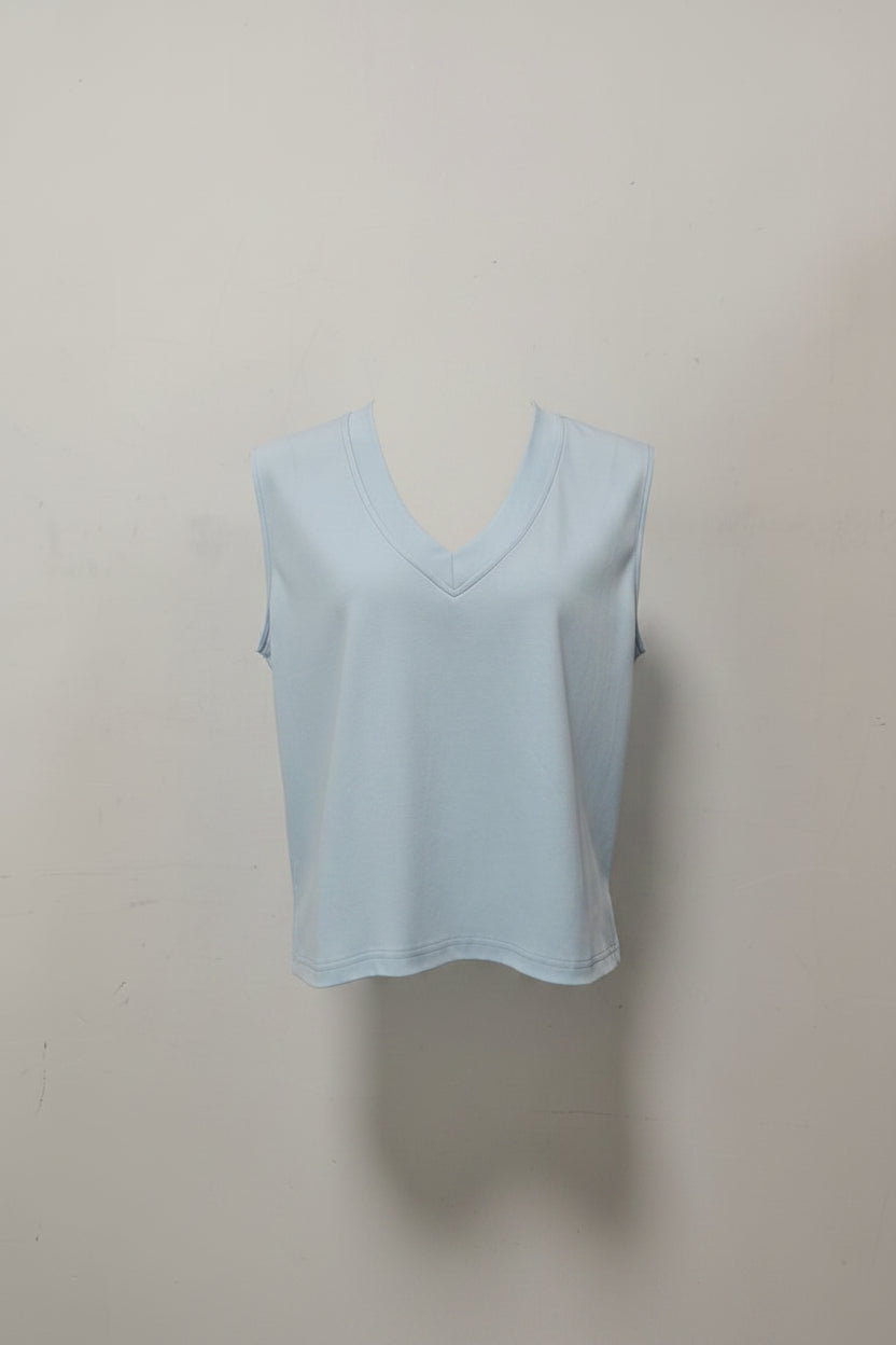 a light blue sleeveless top against a plain background